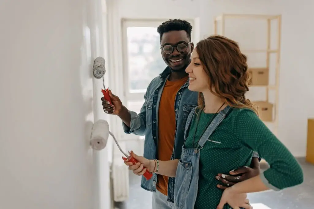Couple repainting a unit in the multi unit home they bought to live in and rent out