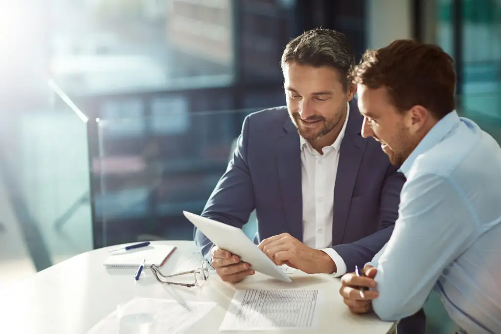 Loan officer reviewing investment property financing options with a real estate investor